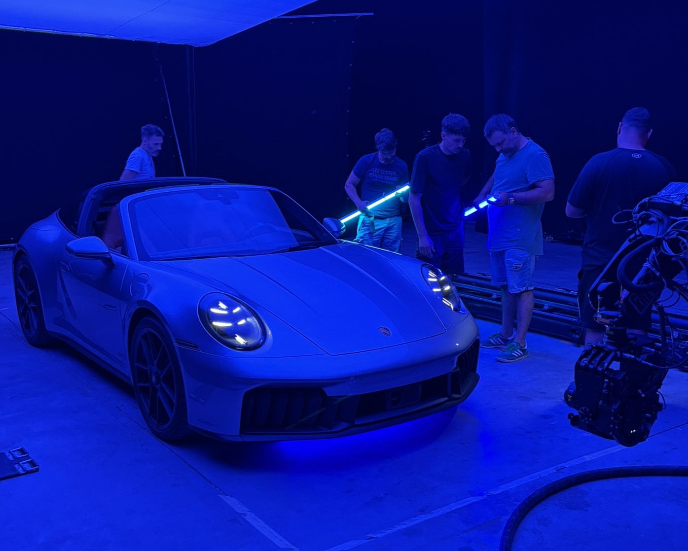 Bolt PTR Capture Porsche 911 exterior with dim-blue shaded lighting while crew setup lighting tubes.